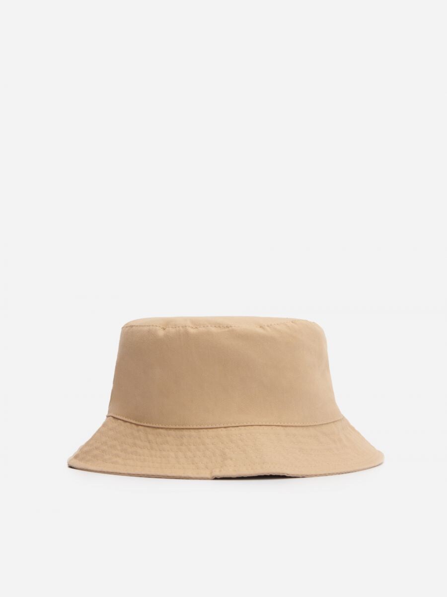 brown trucker hat with smiley face