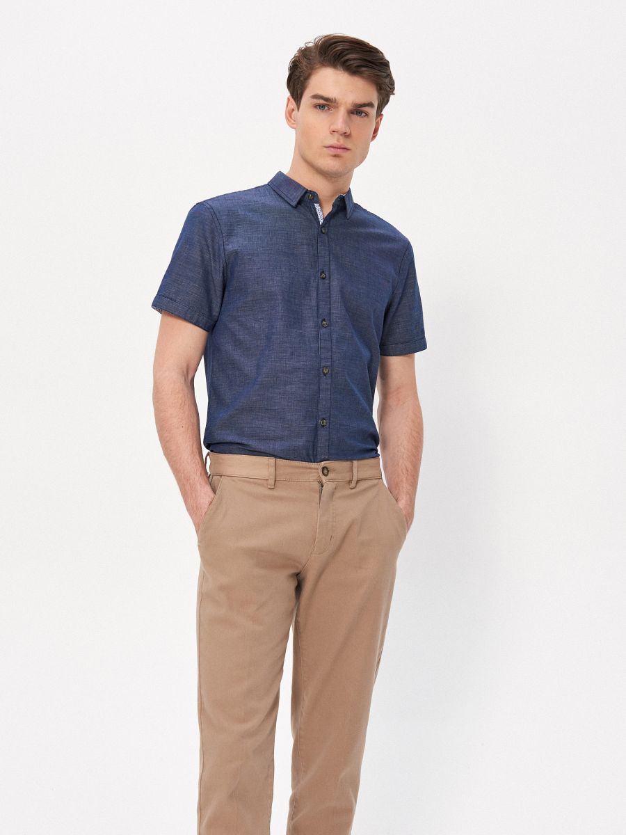 navy shirt beige pants